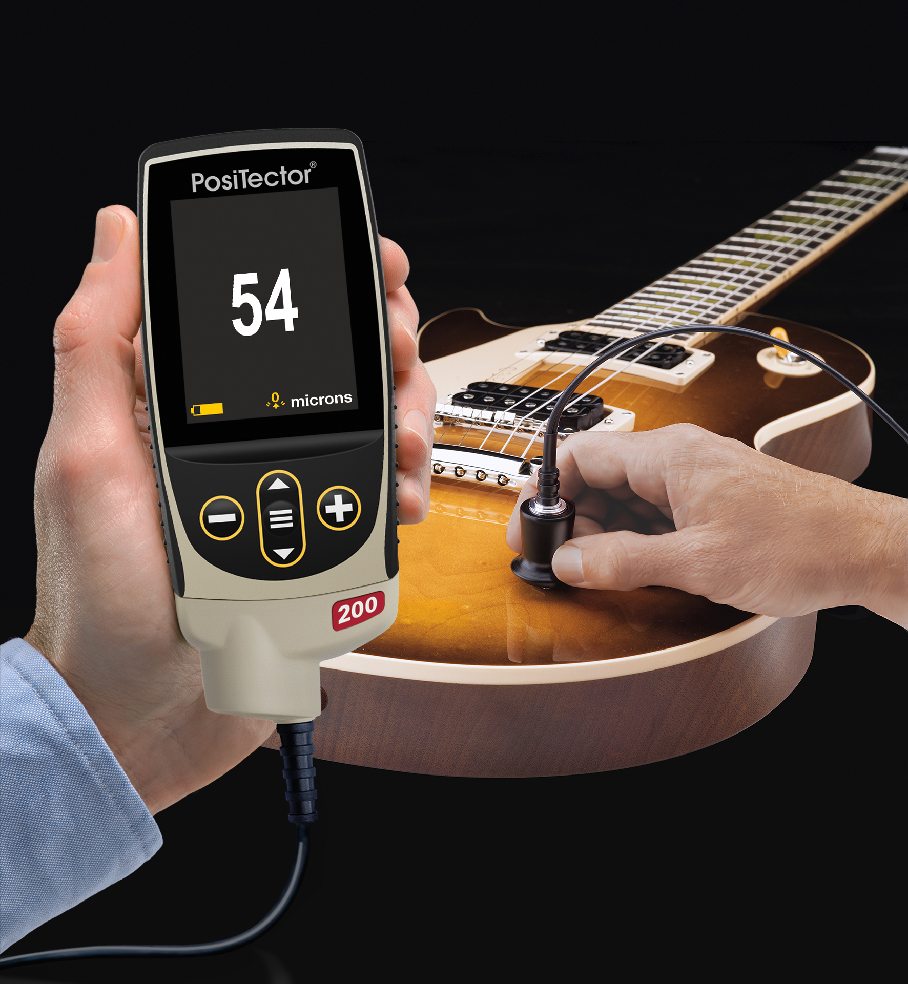 A PosiTector 200 probe touches the coated wooden body of an electric guitar.